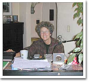 Margie Adam sitting at the piano.