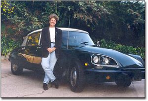 Margie Adam standing next to her Citroen