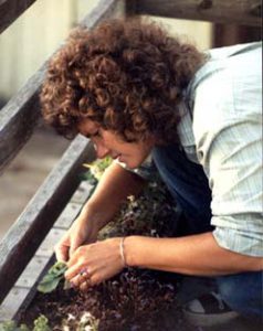 Margie Adam working i nthe garden.