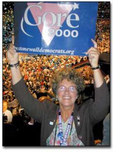 Margie Adam holding a Gore 2000 sign.