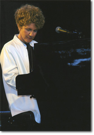 Margie Adam playing the piano.