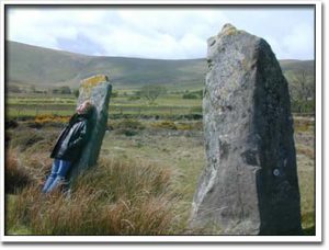 Margie Adam in a swoon with standing stones at Cym Gawr Farm near Crymych, South Wales