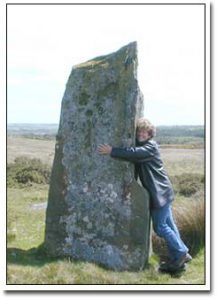 Margie Adam in a swoon with standing stones at Cym Gawr Farm near Crymych, South Wales