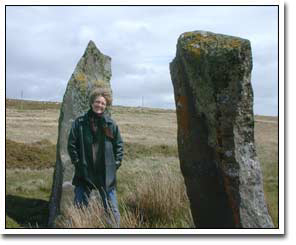 Margie Adam in a swoon with standing stones at Cym Gawr Farm near Crymych, South Wales